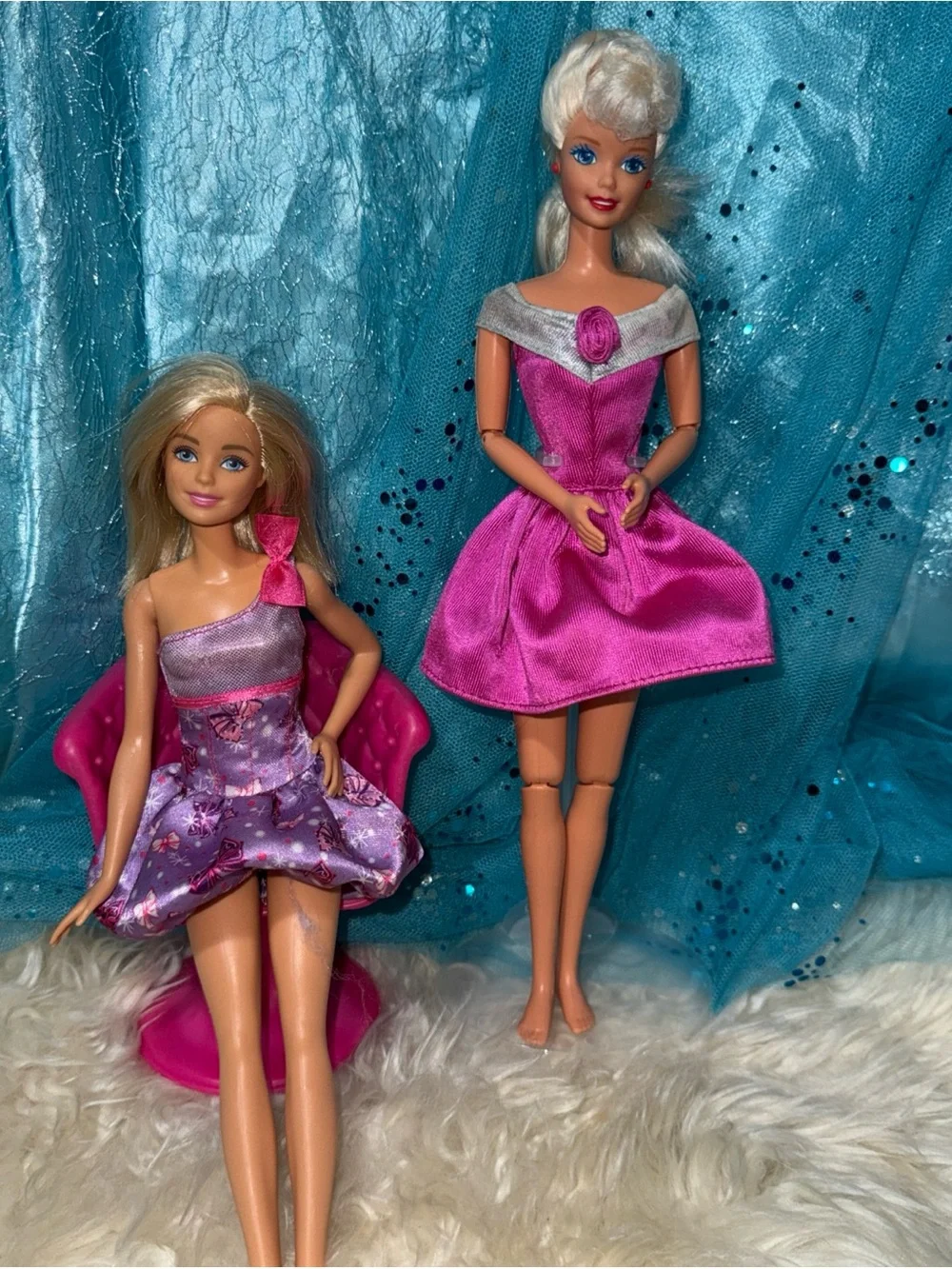 2 Barbie dolls in dresses 1 vintage 1 new chair not included
